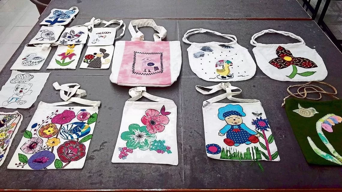 Some of the embroidered and handpainted bags created by the women prisoners in Tihar.